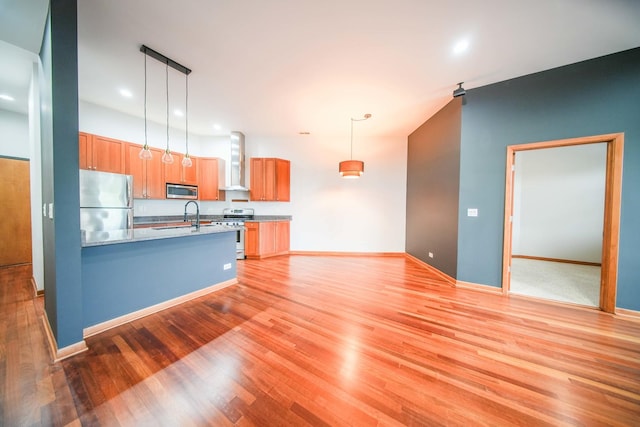 4770 N Manor Ave Unit 405, Chicago, IL 60625 - kitchen featuring stainless steel appliances, wall chimney range hood, a sink, light wood-type flooring, and recessed lighting