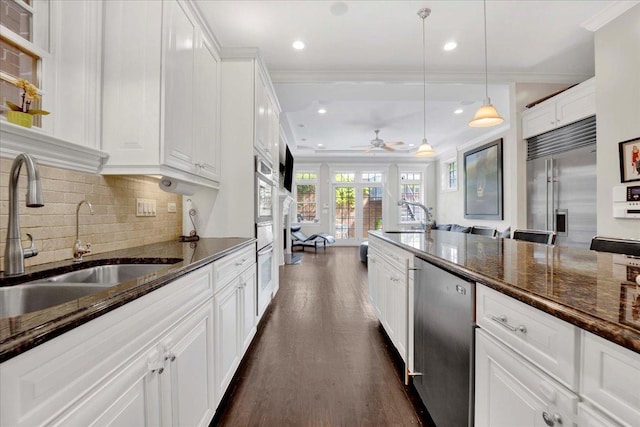 1332 W Wellington Ave, Chicago, IL 60657 - kitchen with a sink, appliances with stainless steel finishes, dark wood-style flooring, crown molding, and white cabinets