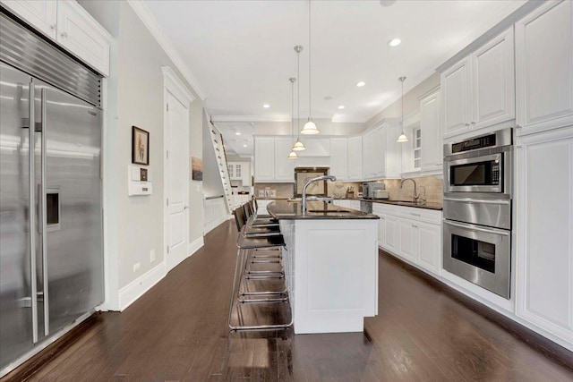 1332 W Wellington Ave, Chicago, IL 60657 - kitchen with built in appliances, dark wood-style flooring, a warming drawer, decorative backsplash, and ornamental molding