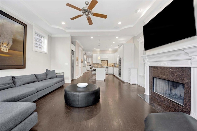 1332 W Wellington Ave, Chicago, IL 60657 - living room with ceiling fan, dark wood-style floors, ornamental molding, a high end fireplace, and recessed lighting