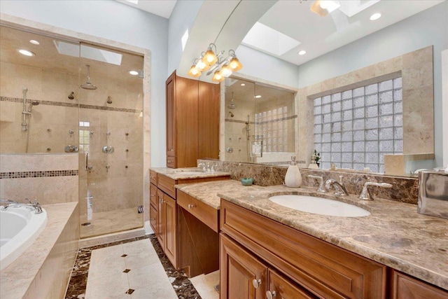 1332 W Wellington Ave, Chicago, IL 60657 - bathroom with a shower stall, a bath, vanity, a skylight, and recessed lighting