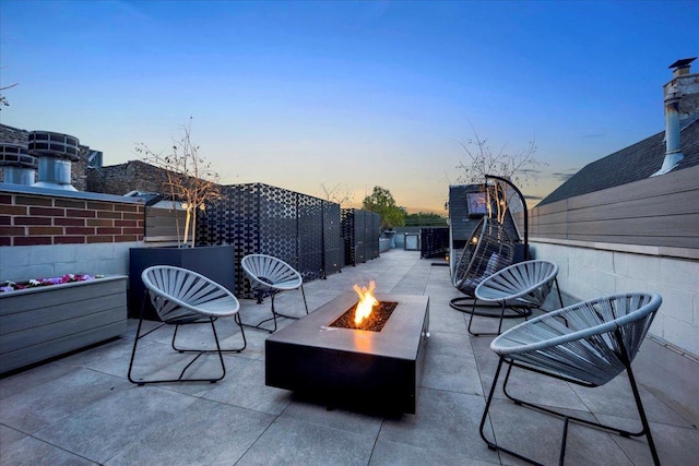 1332 W Wellington Ave, Chicago, IL 60657 - patio terrace at dusk with an outdoor fire pit and a patio area