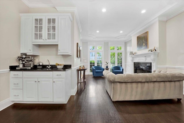1332 W Wellington Ave, Chicago, IL 60657 - kitchen with ornamental molding, open floor plan, dark countertops, white cabinetry, and dark wood-style flooring