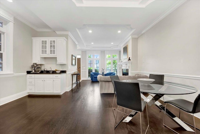 1332 W Wellington Ave, Chicago, IL 60657 - dining area featuring dark wood-style flooring, recessed lighting, crown molding, a fireplace, and baseboards