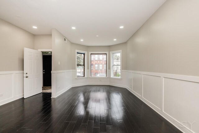 3651 W Grenshaw St, Chicago, IL 60624 - empty room with a wainscoted wall, wood finished floors, and a decorative wall