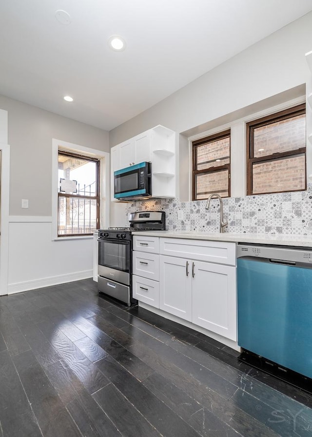 3651 W Grenshaw St, Chicago, IL 60624 - kitchen with stainless steel appliances, open shelves, light countertops, decorative backsplash, and white cabinetry