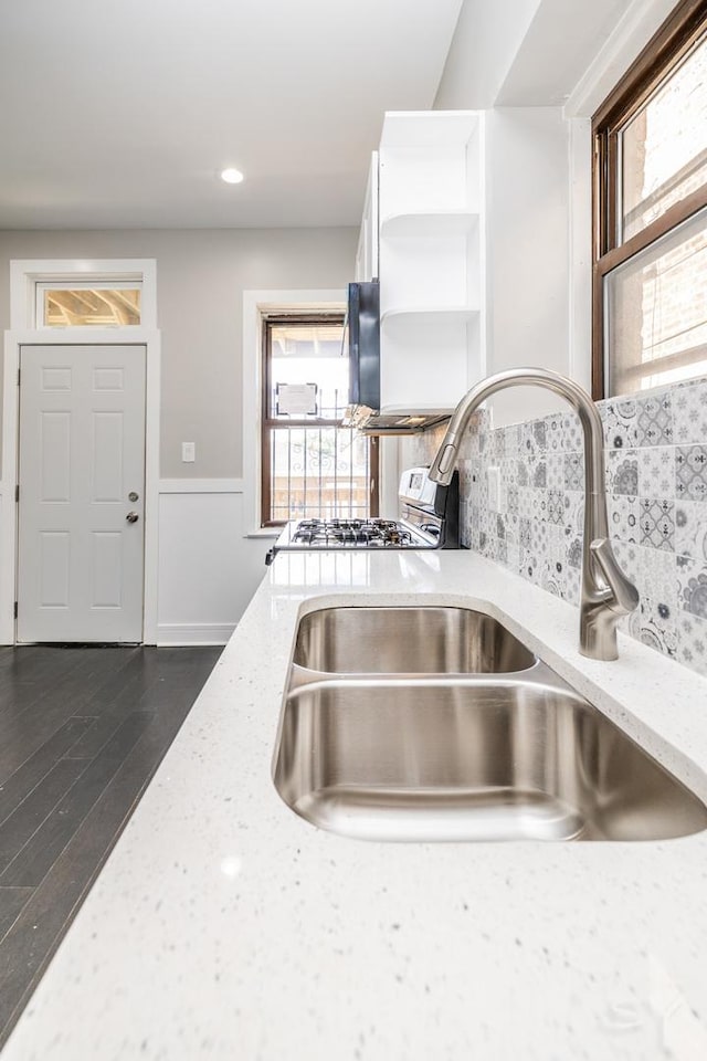 3651 W Grenshaw St, Chicago, IL 60624 - kitchen view of open shelves, white cabinets, light stone countertops, decorative backsplash, and dark wood-style flooring