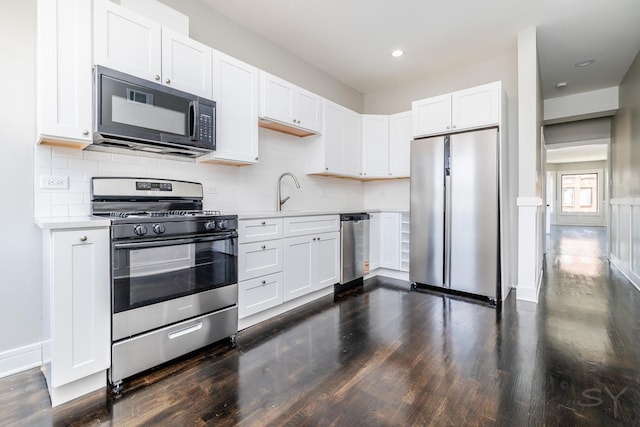 3651 W Grenshaw St, Chicago, IL 60624 - kitchen featuring stainless steel appliances, dark wood-type flooring, light countertops, white cabinetry, and recessed lighting