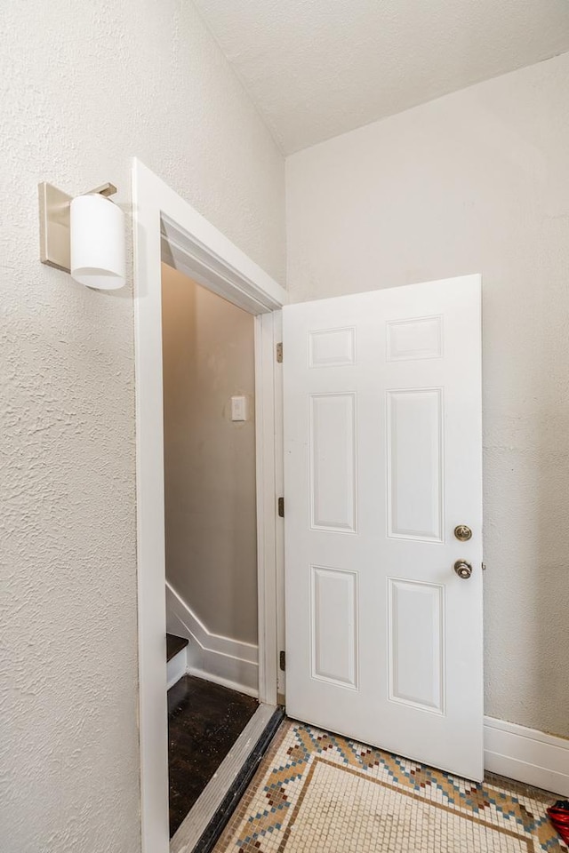 3651 W Grenshaw St, Chicago, IL 60624 - hallway with a textured wall and tile patterned floors