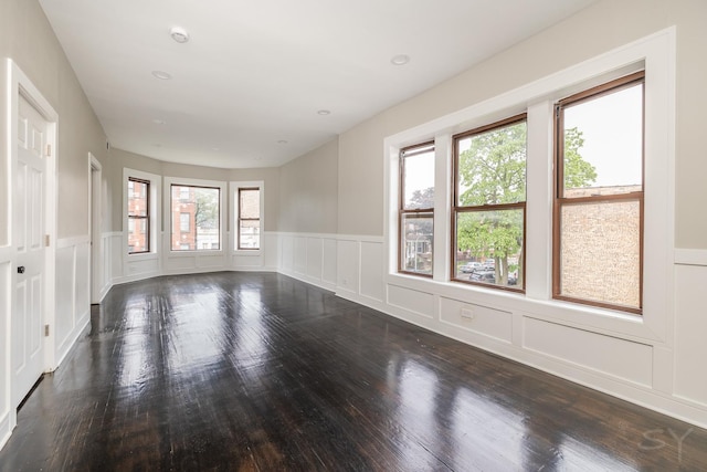 3651 W Grenshaw St, Chicago, IL 60624 - empty room with wood finished floors, a decorative wall, wainscoting, a smoke detector, and recessed lighting