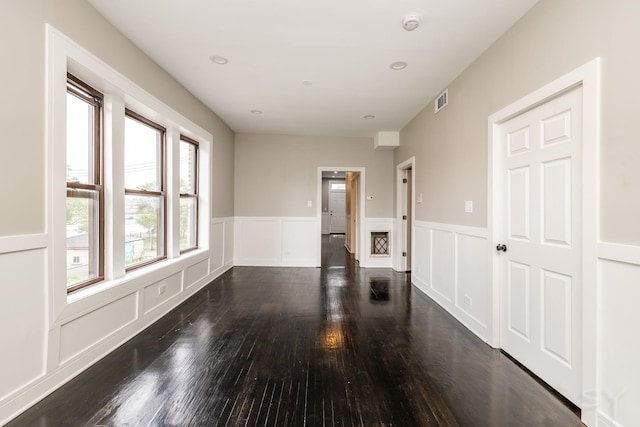 3651 W Grenshaw St, Chicago, IL 60624 - unfurnished room featuring wood finished floors, wainscoting, and a decorative wall