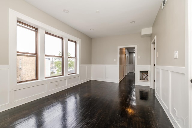 3651 W Grenshaw St, Chicago, IL 60624 - unfurnished room featuring a decorative wall, wood finished floors, and a wainscoted wall