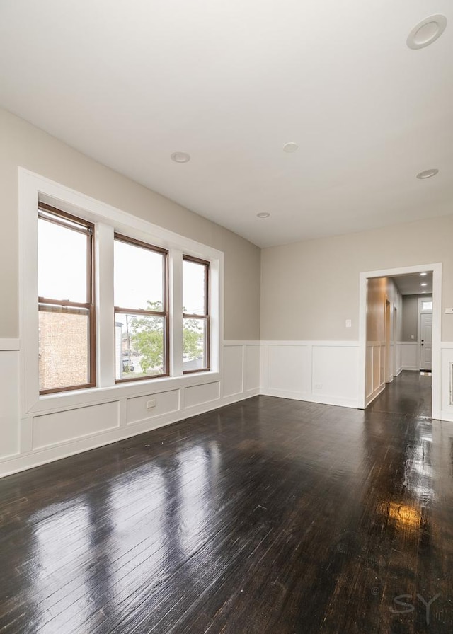 3651 W Grenshaw St, Chicago, IL 60624 - unfurnished room with hardwood / wood-style floors, a decorative wall, and wainscoting