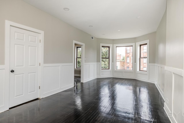 3651 W Grenshaw St, Chicago, IL 60624 - spare room with a wainscoted wall, a decorative wall, and wood finished floors