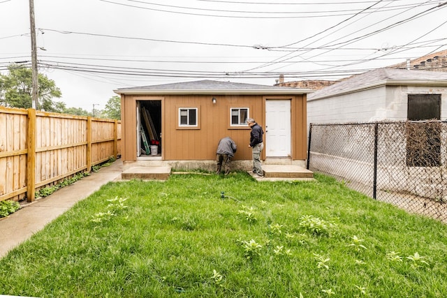 3651 W Grenshaw St, Chicago, IL 60624 - back of property with a fenced backyard, an outbuilding, and entry steps