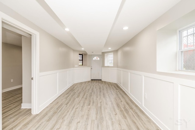 3651 W Grenshaw St, Chicago, IL 60624 - empty room featuring light wood finished floors, healthy amount of natural light, wainscoting, recessed lighting, and a decorative wall