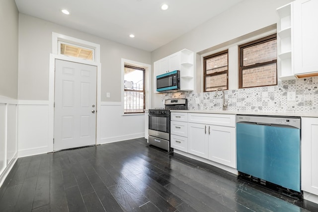 3651 W Grenshaw St, Chicago, IL 60624 - kitchen featuring range with gas cooktop, dishwashing machine, stainless steel microwave, open shelves, and wainscoting