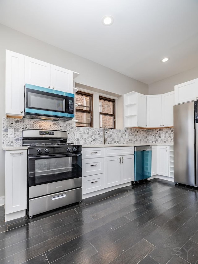 3651 W Grenshaw St, Chicago, IL 60624 - kitchen with appliances with stainless steel finishes, open shelves, dark wood-style flooring, and recessed lighting