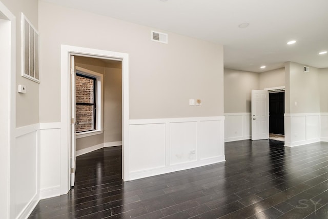 3651 W Grenshaw St, Chicago, IL 60624 - empty room featuring dark wood finished floors, a wainscoted wall, a decorative wall, and recessed lighting