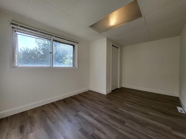 37714 N Nippersink Pl, Spring Grove, IL 60081 - unfurnished bedroom featuring dark wood-style flooring, baseboards, and a drop ceiling