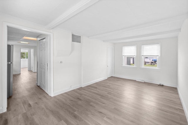 37714 N Nippersink Pl, Spring Grove, IL 60081 - spare room featuring beam ceiling, light wood-type flooring, and baseboards