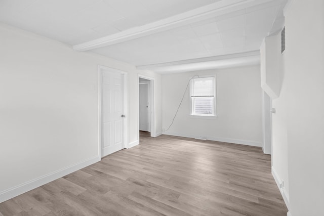 37714 N Nippersink Pl, Spring Grove, IL 60081 - empty room with light wood-style floors, baseboards, and beam ceiling