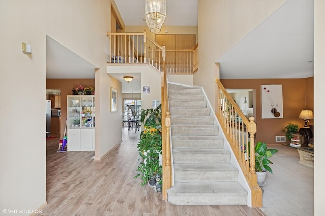 6416 Pasture Side Trl, Matteson, IL 60443 - staircase with a towering ceiling, wood finished floors, and a chandelier