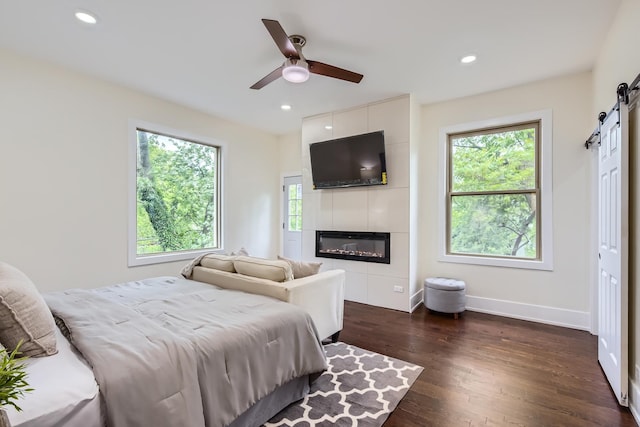 9556 S Winchester Ave, Chicago, IL 60643 - bedroom with a barn door, multiple windows, a large fireplace, dark wood finished floors, and recessed lighting