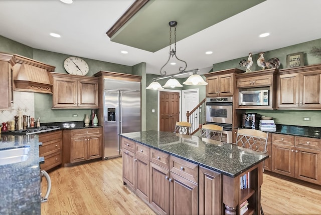 2559 Bird Ln, Batavia, IL 60510 - kitchen featuring built in appliances, light wood-style flooring, a kitchen island, open shelves, and decorative light fixtures