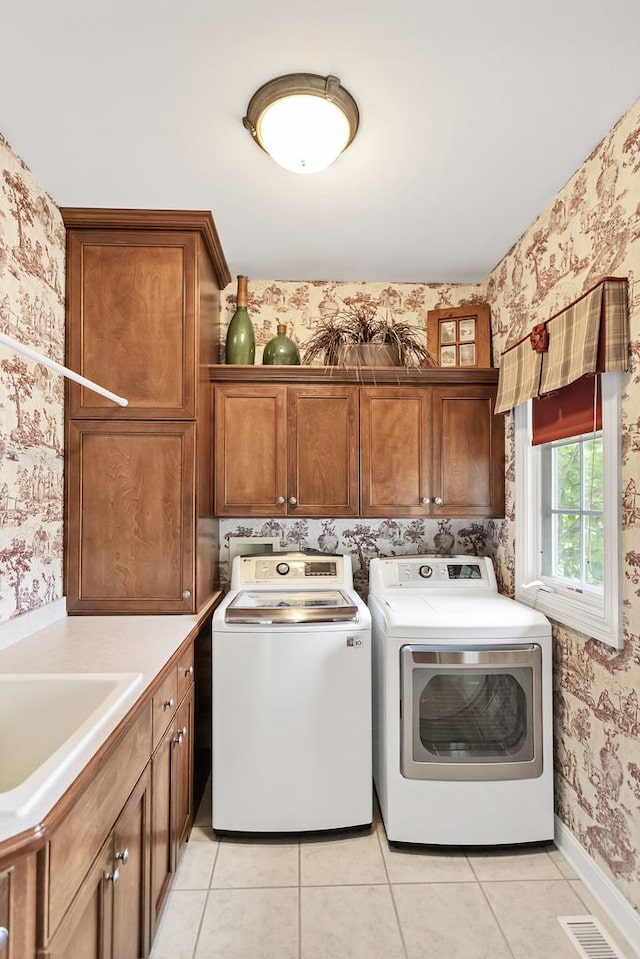 2559 Bird Ln, Batavia, IL 60510 - washroom featuring wallpapered walls, cabinet space, washing machine and clothes dryer, light tile patterned flooring, and baseboards