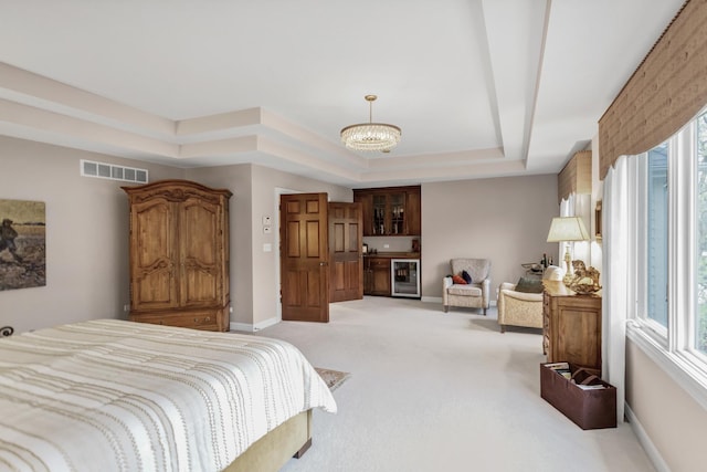 2559 Bird Ln, Batavia, IL 60510 - bedroom with a tray ceiling, wine cooler, light colored carpet, a chandelier, and baseboards