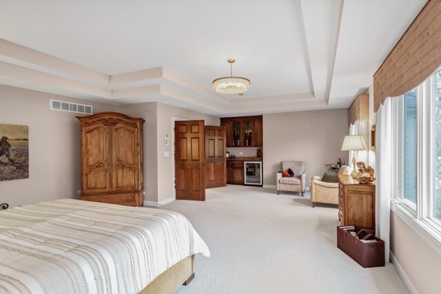 2559 Bird Ln, Batavia, IL 60510 - bedroom with a tray ceiling, light carpet, a chandelier, wine cooler, and baseboards