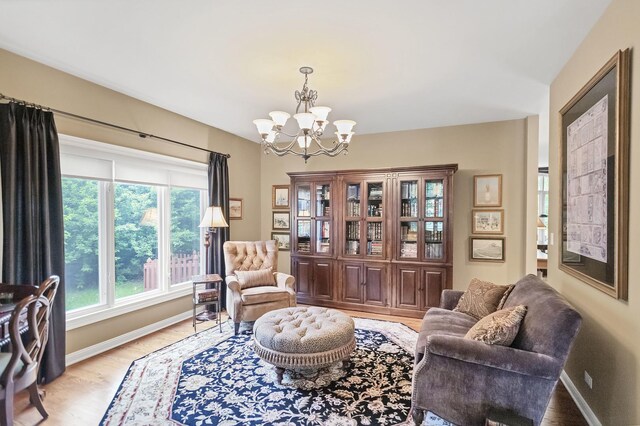 2559 Bird Ln, Batavia, IL 60510 - living area featuring a chandelier, baseboards, and light wood-type flooring
