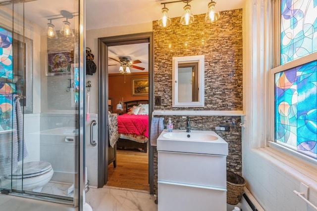 5555 N Sheridan Rd Unit 309, Chicago, IL 60640 - bathroom with vanity, a shower stall, marble finish floors, toilet, and connected bathroom