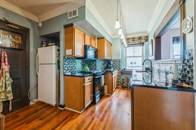 5555 N Sheridan Rd Unit 309, Chicago, IL 60640 - kitchen featuring black appliances, dark countertops, dark wood-type flooring, brown cabinets, and a sink