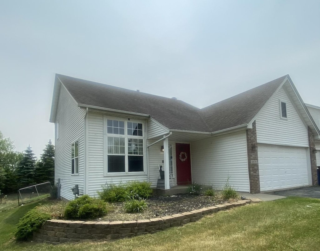 5476 Bastian Blvd, South Beloit, IL 61080 - view of front facade with a shingled roof and asphalt driveway