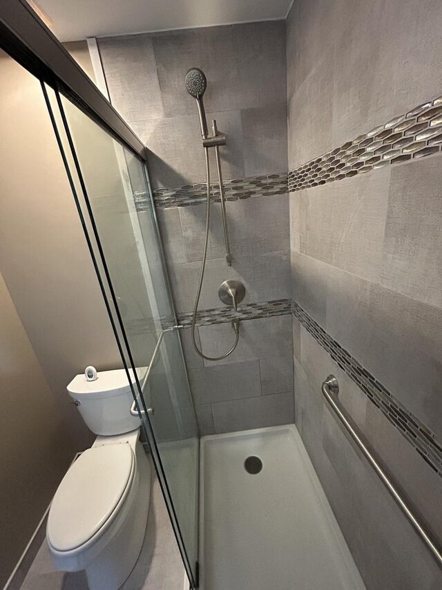 1778 Gloucester Ct Unit B, Wheaton, IL 60189 - bathroom with a stall shower, toilet, and tile patterned floors