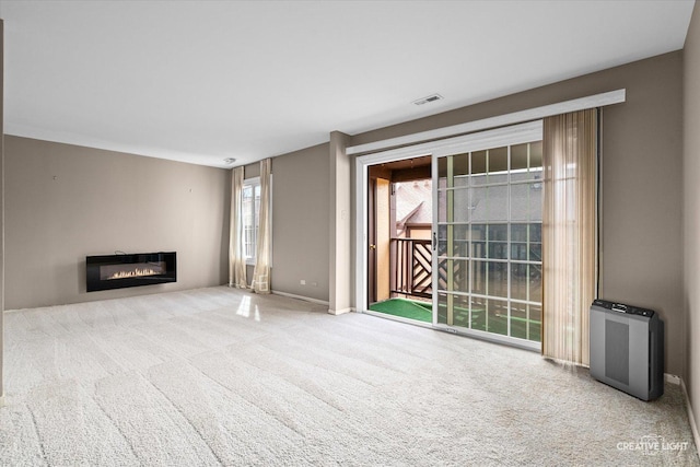 1778 Gloucester Ct Unit B, Wheaton, IL 60189 - unfurnished living room with carpet, a glass covered fireplace, and baseboards