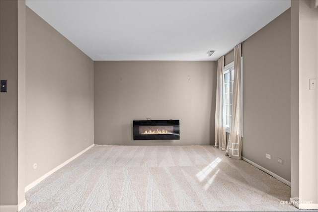 1778 Gloucester Ct Unit B, Wheaton, IL 60189 - unfurnished living room with a glass covered fireplace, carpet, and baseboards