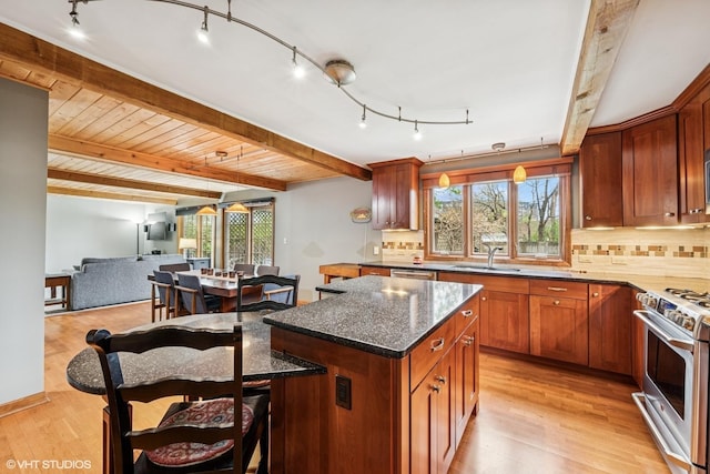 218 S Owen St, Mount Prospect, IL 60056 - kitchen with stainless steel gas range oven, light wood-style flooring, tasteful backsplash, open floor plan, and beamed ceiling