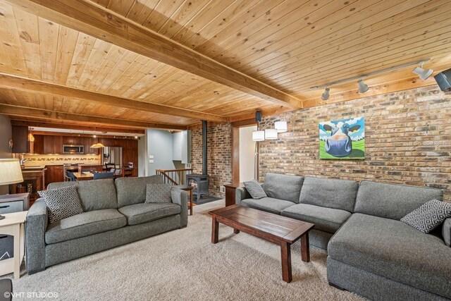 218 S Owen St, Mount Prospect, IL 60056 - carpeted living area featuring brick wall, a wood stove, and a wood ceiling with exposed beams