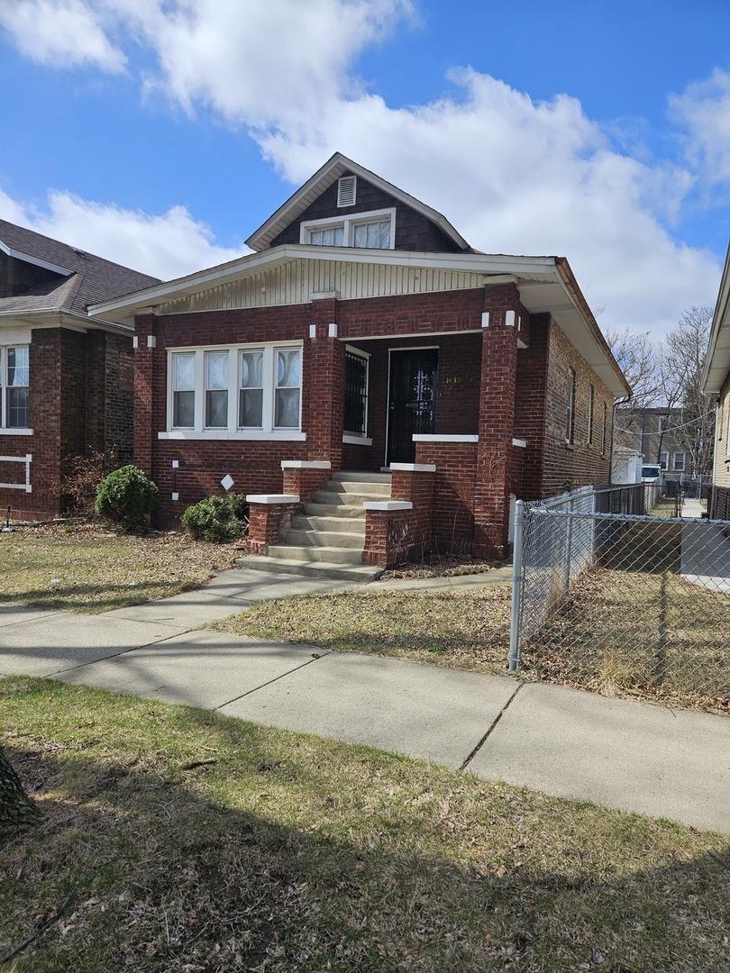 bungalow-style house with covered porch and brick siding