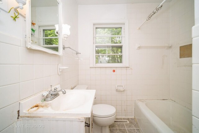 1731 Maple Ave, Northbrook, IL 60062 - bathroom with tile walls, plenty of natural light, vanity, washtub / shower combination, and tile patterned flooring
