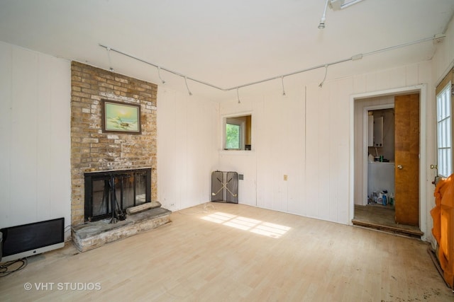 1731 Maple Ave, Northbrook, IL 60062 - unfurnished living room with wood finished floors, track lighting, and a fireplace
