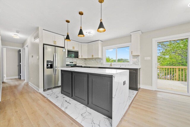 179 Glen Hill Dr, Glendale Heights, IL 60139 - kitchen with stainless steel appliances, white cabinetry, tasteful backsplash, and a kitchen island
