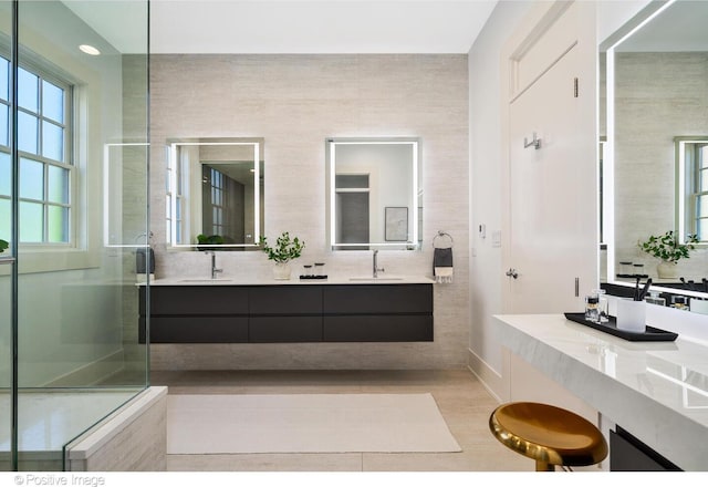 2015 N Howe St, Chicago, IL 60614 - bathroom featuring double vanity, wood finished floors, an enclosed shower, and baseboards