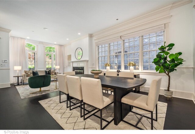 2015 N Howe St, Chicago, IL 60614 - dining space featuring crown molding, baseboards, a fireplace, wood finished floors, and recessed lighting