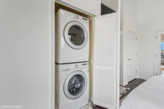 1444 N Bosworth Ave Unit 3S, Chicago, IL 60642 - laundry room featuring stacked washing machine and dryer, wood finished floors, and baseboards