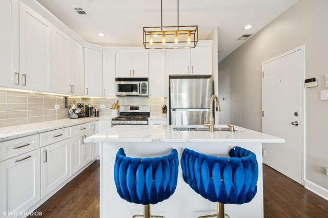 1444 N Bosworth Ave Unit 3S, Chicago, IL 60642 - kitchen with appliances with stainless steel finishes, tasteful backsplash, dark wood finished floors, white cabinetry, and recessed lighting