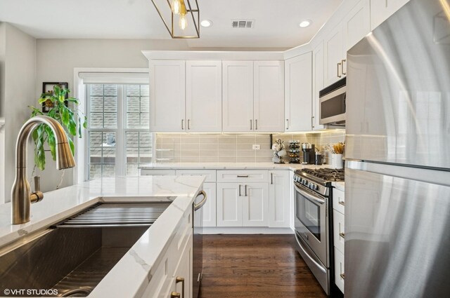 1444 N Bosworth Ave Unit 3S, Chicago, IL 60642 - kitchen with stainless steel appliances, a sink, white cabinetry, decorative backsplash, and recessed lighting